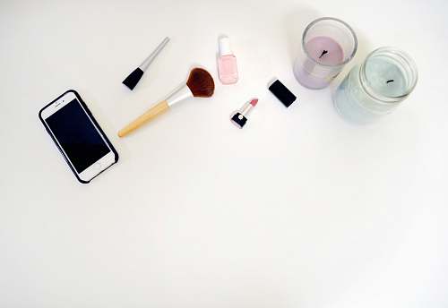 makeup styled stock silver iPhone 6 beside makeup brush flat lay